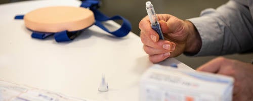 Practitioner holding injection product