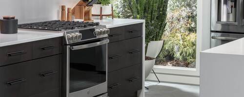 A picture perfect kitchen filled with GE IoT connected appliances, microwave, stove, refrigerator and dishwasher