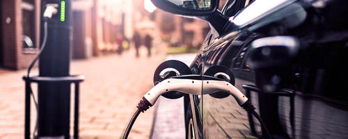 Electric vehicle charging cable plugged into an electric vehicle port