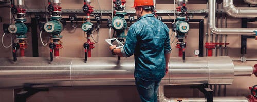Electrical engineer working in an industrial boiler control room