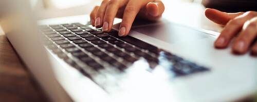 woman typing a laptop computer