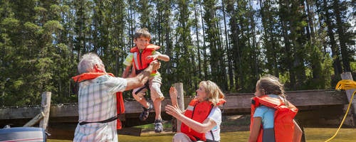 A family going boating wearing life vests