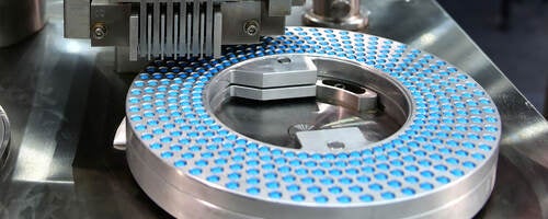 Blue capsule pack at medicine pill production line