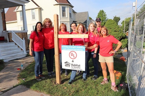 UL CSR employees stand before the Habitat for Humanity house in Elgin, IL