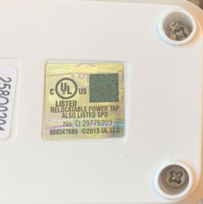 Close up of a UL label on the bottom of a power strip