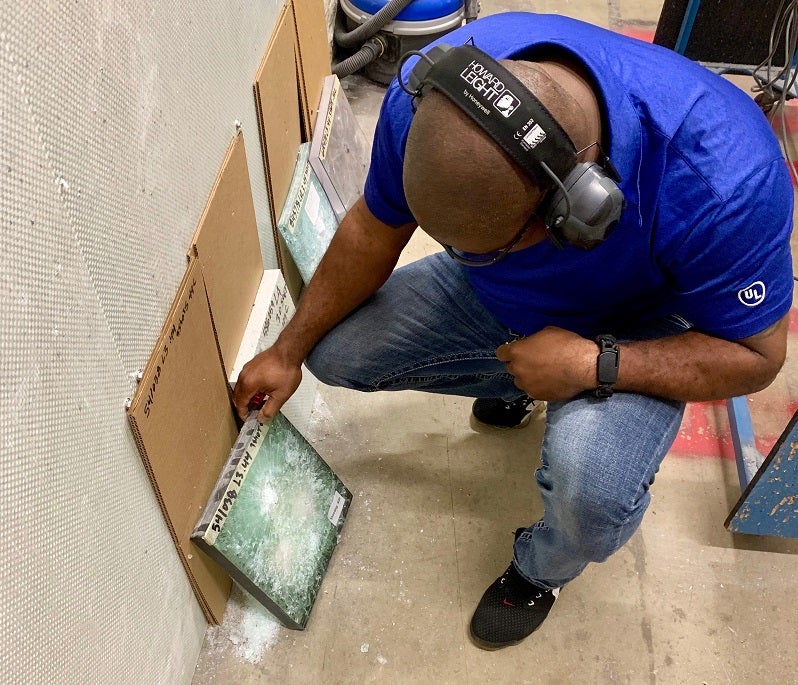 Gardner checks the results of ballistics testing on a glass sample.