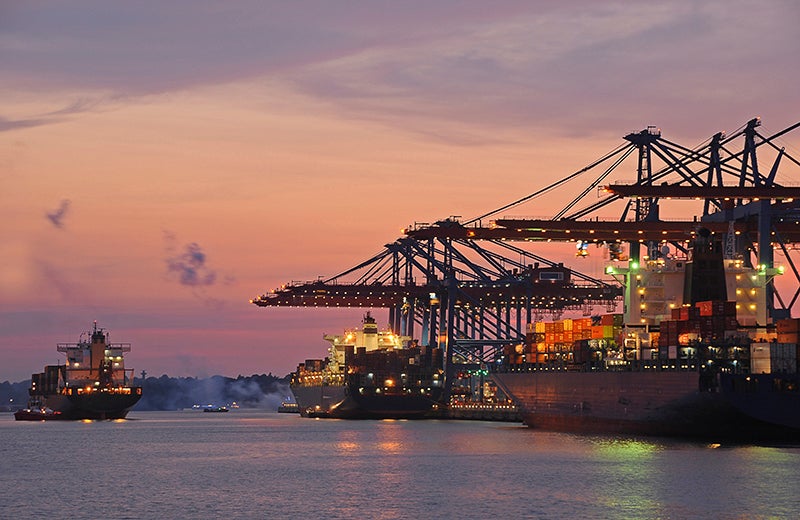 container ship at port at sunset