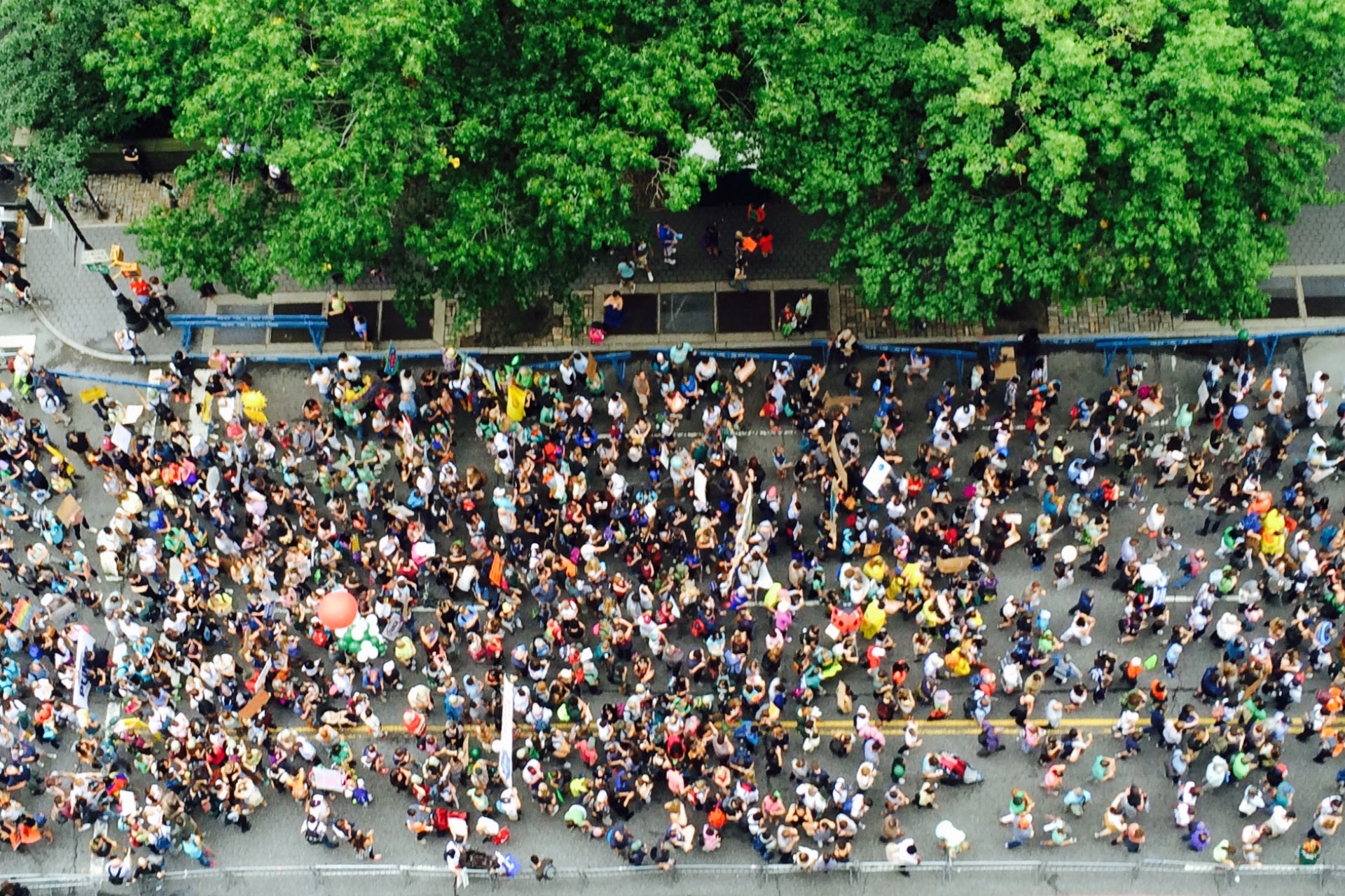 An aerial view of a crowd of protester marching down a city street