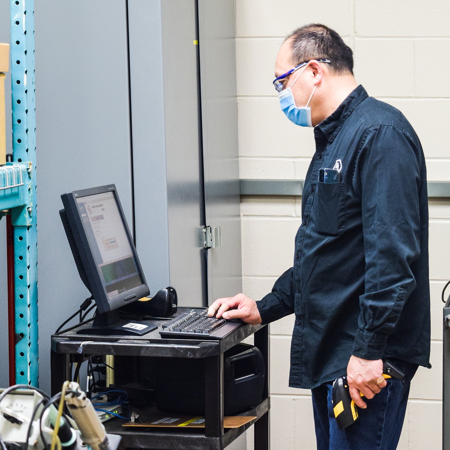 UL employee working on a computer while wearing a surgical mask