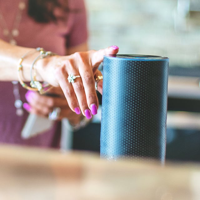 Woman activating a smart speaker