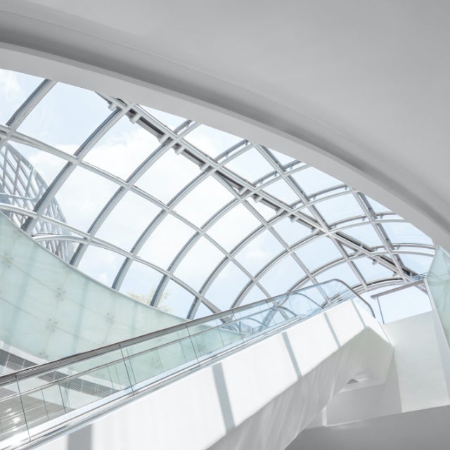 A modern escalator and skylight inside an office building