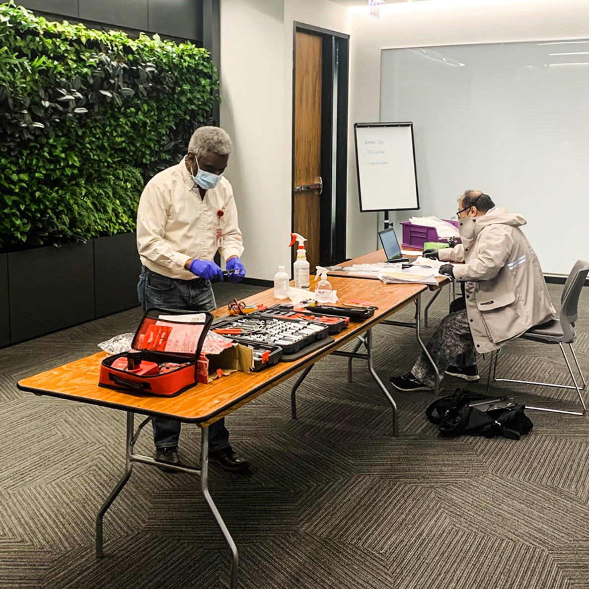 UL employees setting up a response table in a conference room