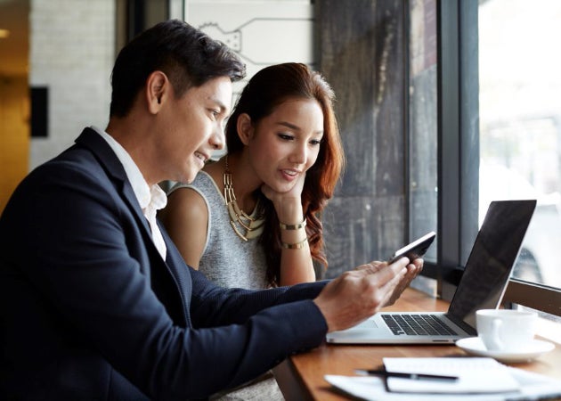 A Latino business woman and man discuss ideas over coffee