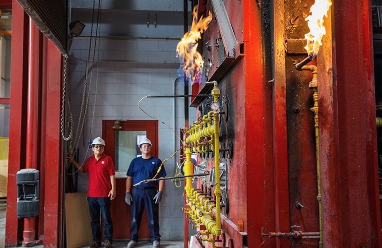 Two engineers conducting a firestopping test