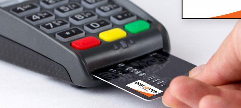 Customer using Discover card in a card reader