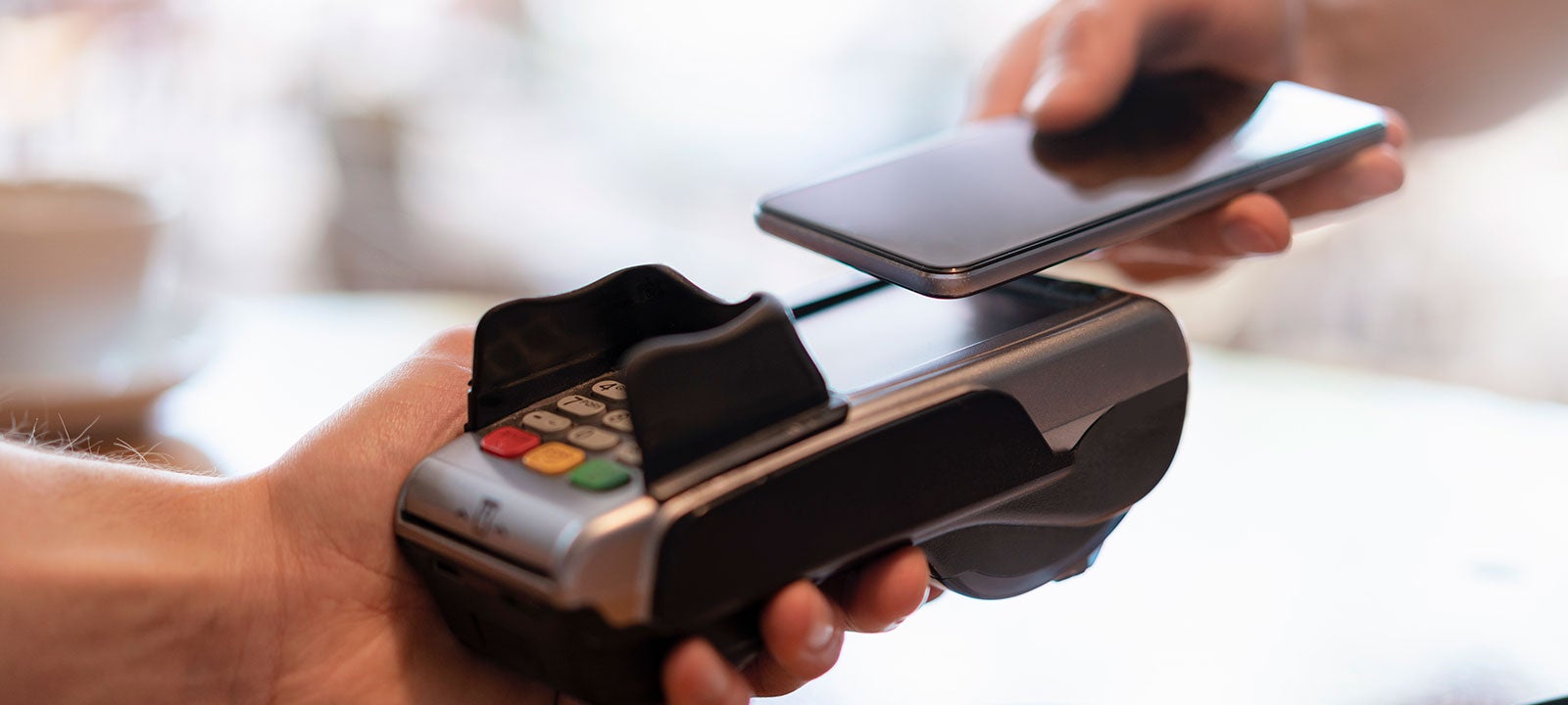 Customer using a cellphone to pay at a store